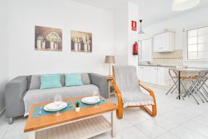 a living room with a couch and a table at Apto B-A almoraide suites in Nerja