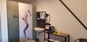 a bathroom with a sink and a persons shadow on the wall at Eventhotel Ö - Cappuccino in Geiselwind +165 photos