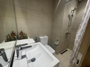 a bathroom with a sink and a shower and a toilet at Sophisticated Studio Designer Interiors in Dubai