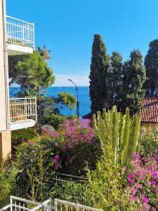 a view from the balcony of a house with flowers at Pian di Poma House in Sanremo