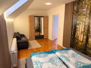a bedroom with a bed and a couch at Fewo Zentral in Willingen