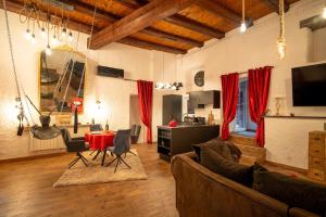 ein Wohnzimmer mit Sofa und Tisch in der Unterkunft Le Confidentiel - Le Refuge de vos Désirs secrets in Sélestat