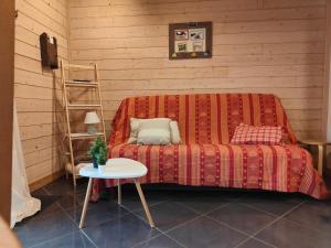 a room with a couch with a table and a ladder at la ratavelaiza in Champagny-en-Vanoise