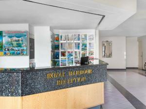 a lobby of a hotel with a reception counter at BreakFree Royal Harbour in Cairns