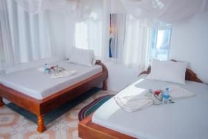 Postel nebo postele na pokoji v ubytování Mudi House