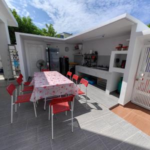a patio with a table and chairs and a kitchen at VnV DORM HOMESTAY in Shah Alam