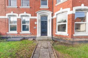 a brick house with a blue door and windows at WhiskAwayHomes - St Stephens Court - Apartment 2 in Henwick