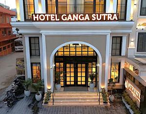 a hotel entrance with a hotel gangaea sudirman at Hotel Ganga Sutra in Haridwār