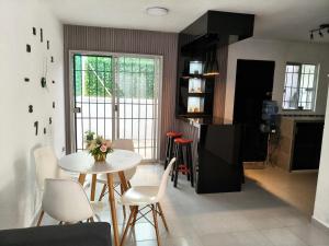 Una cocina y un comedor con mesa y sillas. en Casa en Residencial 2 ríos 4 camas 3 habitaciones, en Dos Ríos