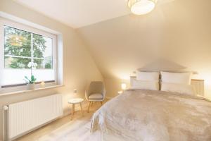 Ένα ή περισσότερα κρεβάτια σε δωμάτιο στο NEU Hütthus Ferienhaus in Timmendorfer Strand