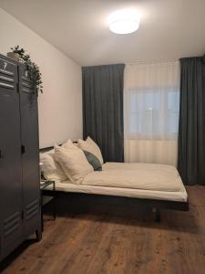 a bed sitting in a room with a window at Ferienwohnung Strizi in Ruhpolding