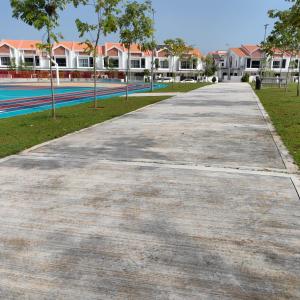 an empty sidewalk in front of a swimming pool at VnV DORM HOMESTAY in Shah Alam