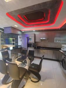a kitchen with a long dining table and chairs at Super villa de haut standing in Dar Merah Deriba +25 photos