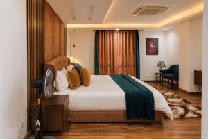 a hotel room with a large bed and a chair at Montressa Executive Stay - Gold Crest Mall Phase 4 Lahore in Lahore +63 photos