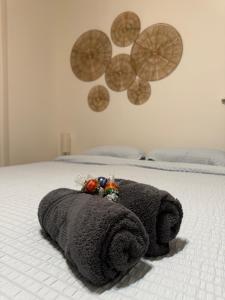 a bed with a rolled up towel on it at The Black Nut NYC in New York