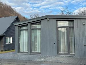 a grey house with windows on a deck at Grey House in Kvasy