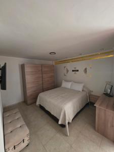 a bedroom with a large bed and a chair at Loft paradisse in Melilla