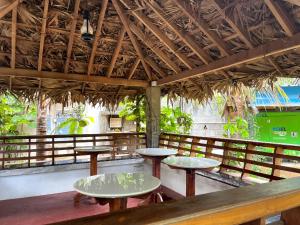 a restaurant with two tables and a roof at Farmdean holiday home in Kovakulam