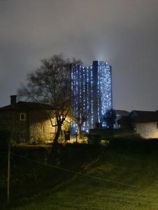 a tall building with lights on it at night at Callisto Vicino al lago con un'atmosfera calorosa e giardino in Dervio