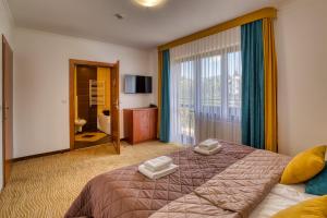 Una cama o camas en una habitación de Hotel Muszyna 89 fotos más