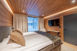 Postel nebo postele na pokoji v ubytování Wilderness Hotel Kieppi