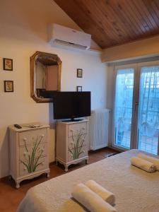 a bedroom with two beds and a flat screen tv at Domus Mari in Fiuggi