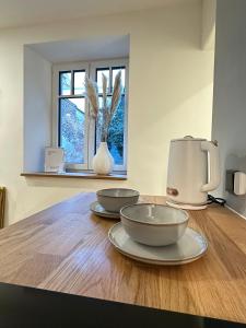 deux bols sur une table en bois avec une cafetière dans l'établissement Fewo Sand 10 - groß, à Bamberg 7 autres photos