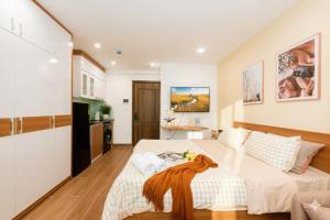 a bedroom with a large bed in a room at Aurelia Aparthotel Hanoi in Hanoi