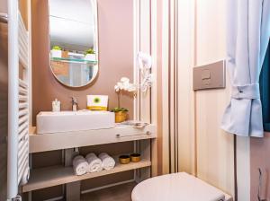 a bathroom with a sink and a mirror at Hotiday Bologna Arena in Bologna