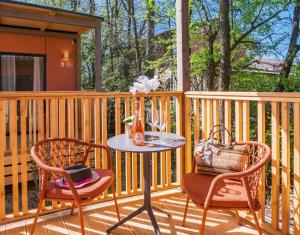 a patio with two chairs and a table on a deck at Hotiday Bologna Arena in Bologna +10 photos