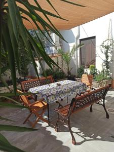 a table and four chairs and a table and a table and chairs at Casa Vacanze AnnaLù IUN R5074 in Orosei