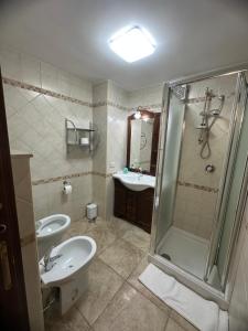 a bathroom with a sink toilet and a shower at Princess Mafalda house in Grottaglie