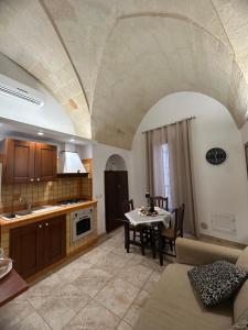 a kitchen with a table and a dining room at Princess Mafalda house in Grottaglie +16 photos