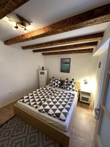 a bedroom with a large bed in a room at Stone house Anja in Vrbnik