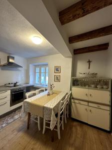 a kitchen with a table and chairs in a room at Stone house Anja in Vrbnik