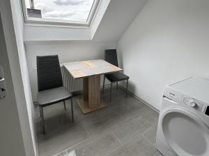 a small bathroom with a table and two chairs at Fully equipped Apartment in Castrop-Rauxel in Castrop-Rauxel