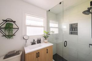 a bathroom with a shower and a sink and a toilet at The County Haus - Indoor Pool & Finnish Sauna in West Lake