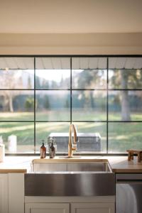 a kitchen with a sink and a large window at The County Haus - Indoor Pool & Finnish Sauna in West Lake