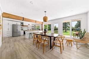a kitchen and dining room with a table and chairs at The County Haus - Indoor Pool & Finnish Sauna in West Lake