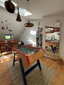 a living room with a foos ball on a table at Spacious house next Kirchberg-Centre with parking in Luxembourg