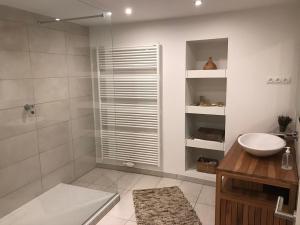 a white bathroom with a sink and a shower at Spacious house next Kirchberg-Centre with parking in Luxembourg +35 photos