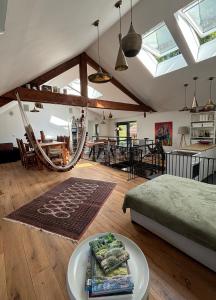 a living room with a bed and a dining room at Spacious house next Kirchberg-Centre with parking in Luxembourg