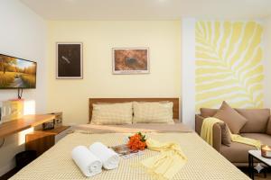 a bedroom with a bed and a couch at Aurelia Aparthotel Hanoi in Hanoi