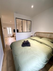 a bedroom with a large bed with two bags on it at Au Passage de Pommard in Pommard