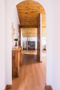 an open room with a wooden ceiling and wooden floors at Our Friends Apartment in Lisbon