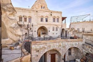 an old stone building with two arched entrances at Mithra Cave Cappadocia in Göreme