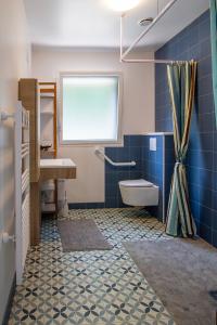 a bathroom with a tub and a sink and a toilet at Jolie maison neuve PMR au port de l'Aberwrac'h in Landéda