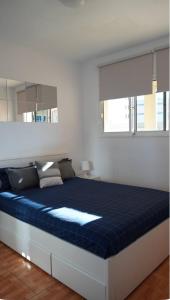 Bett in einem Schlafzimmer mit blauer Matratze in der Unterkunft Apartamento con vista frontal al mar in El Médano