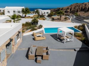 a view of a patio with chairs and a table at Desiterra Resort & Spa in Fira