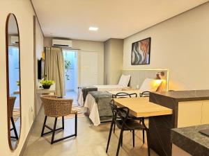 a room with a living room and a bedroom at Tc Lofts in Uberlândia